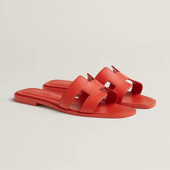Шлепанцы Oran из кожи цвета Orange Capucine HERMES